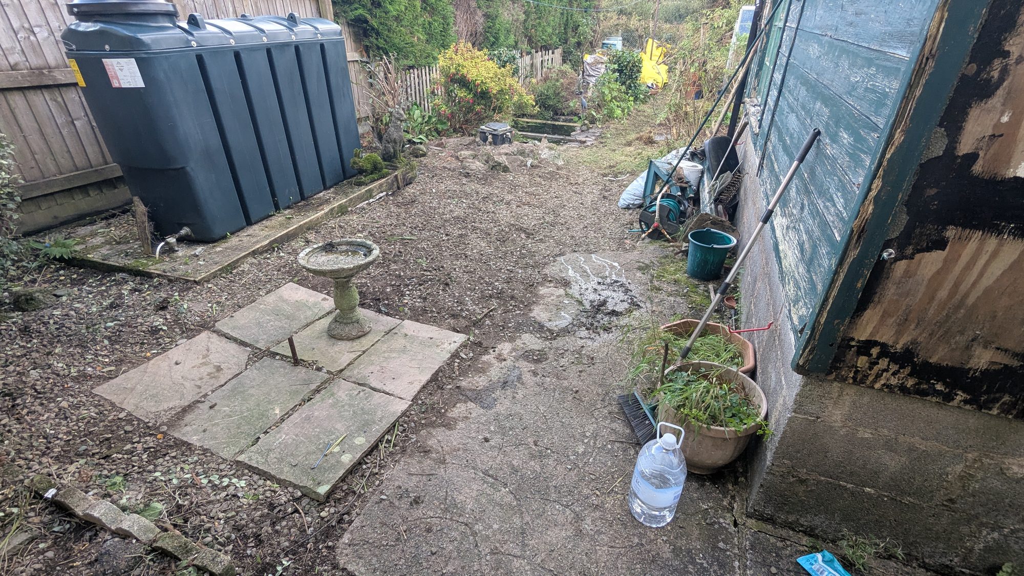 The same area cleared back to gravel and paving with a bird bath in the middle, Haverfordwest